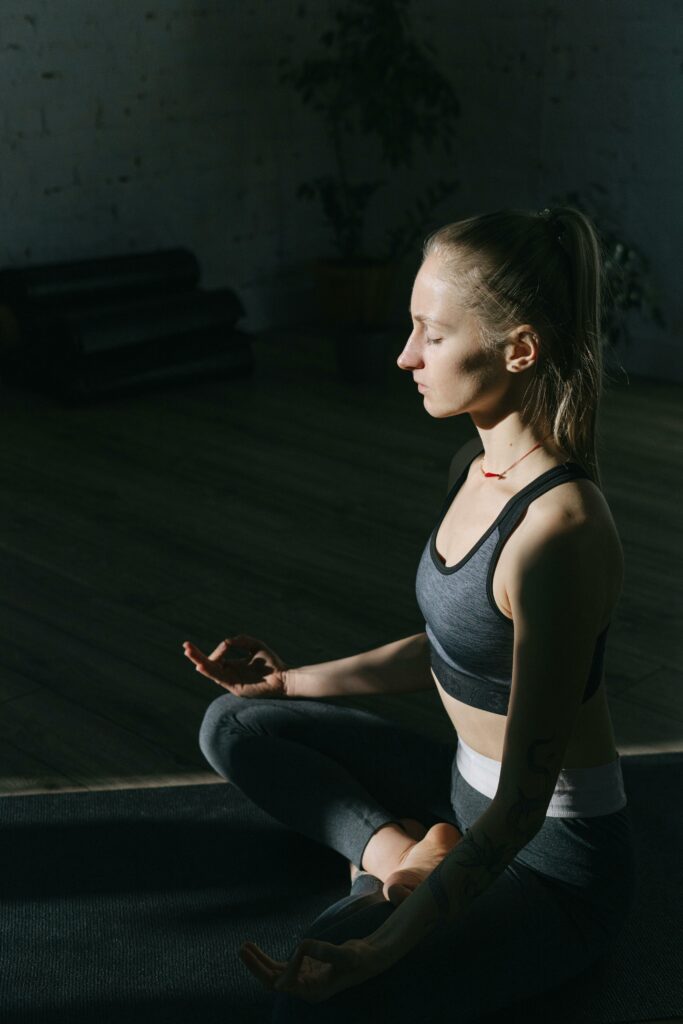 Young woman meditating in a calm indoor space as part of a mindful morning routine